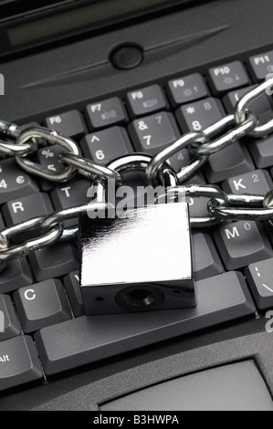 Padlock and Chain on Laptop Computer Keyboard Stock Photo