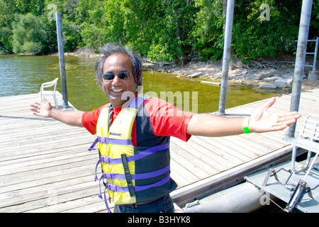 East Indian dragon boat crew member celebrating. Dragon Festival Lake Phalen Park St Paul Minnesota USA Stock Photo