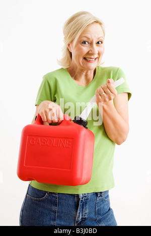 Portrait of smiling adult blonde woman holding gas can Stock Photo