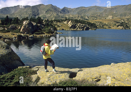 Woman hiker with a map in the Massif of Carlit, Pyrenees Orientales, France Stock Photo