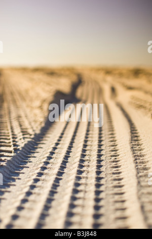 Close up of tire tracks in the sand. Tyre tread marks. Stock Photo