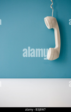 telephone receiver hanging off the hook Stock Photo