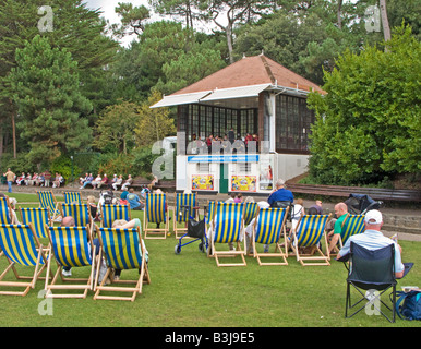 People in deck chairs watching a Concert in Bournemouth Gardens, Dorset, UK Stock Photo