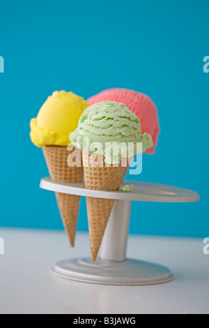 three ice cream cones pistachio, lemon and strawberry Stock Photo