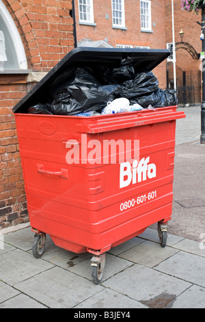 Overflowing red Biffa waste bin on street Ludlow Shropshire UK Stock Photo