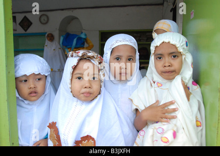 happy muslim children at the charity  sponsored islamic school in slum neighbourhood in kuta , bali , indonesia Stock Photo