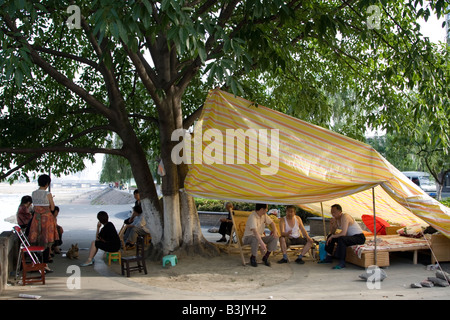 Survivors of the earthquake in Sichuan on 12 May 2008 killing time in a park of makeshift tents housing them in Sichuan, China Stock Photo