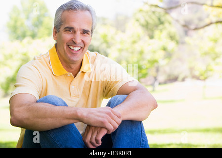 Man sitting outdoors smiling Stock Photo