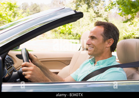 Man in convertible car smiling Stock Photo
