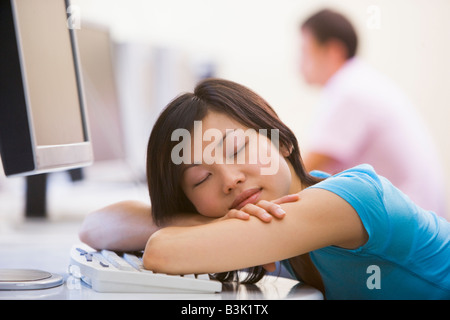 Woman in computer room sleeping Stock Photo