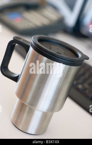 Shot of a reusable coffee cup on a desk Stock Photo