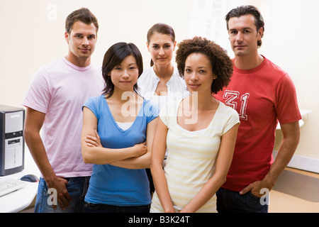 Five people standing in computer room Stock Photo