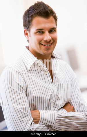 Man standing in computer room smiling Stock Photo