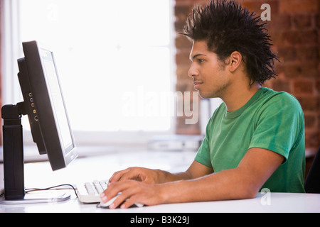 Businessman in office typing on computer Stock Photo