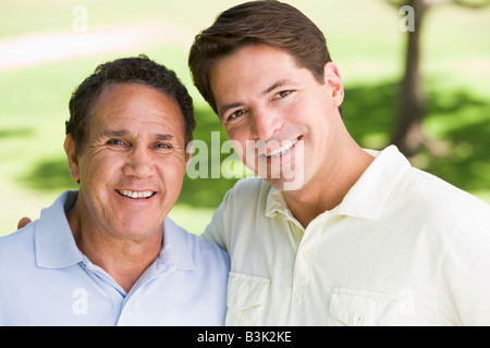 Two men standing outdoors smiling Stock Photo