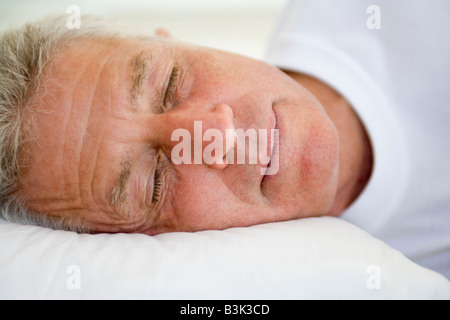 Man lying in bed sleeping Stock Photo