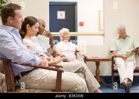 Five people waiting in waiting room Stock Photo