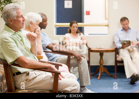 Five people waiting in waiting room Stock Photo