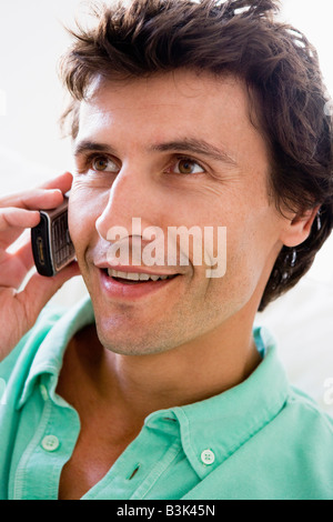 Man using cellular phone and smiling Stock Photo