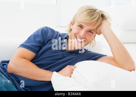 Man sitting in living room smiling Stock Photo