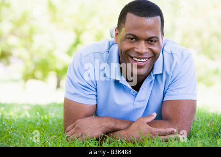 Man lying outdoors smiling Stock Photo