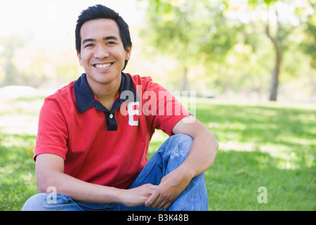 Man sitting outdoors smiling Stock Photo