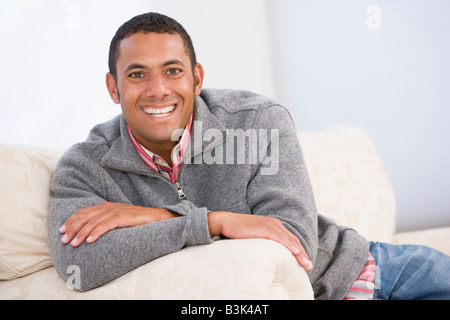 Man sitting in living room smiling Stock Photo