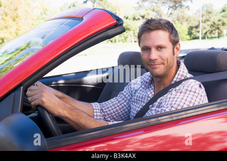 Man in convertible car smiling Stock Photo