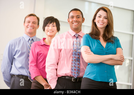 Business team standing indoors smiling Stock Photo