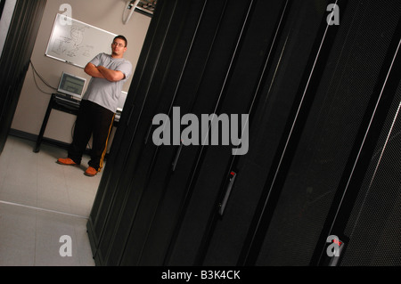 Hispanic computer technician in a network server room Stock Photo
