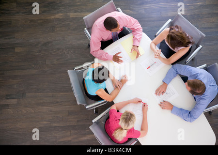 Five businesspeople at boardroom table Stock Photo