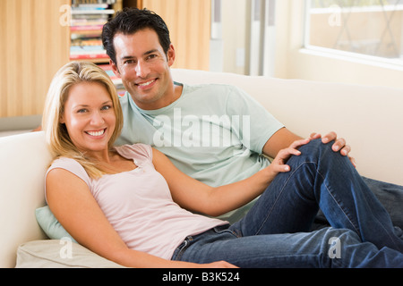 Couple in living room smiling Stock Photo