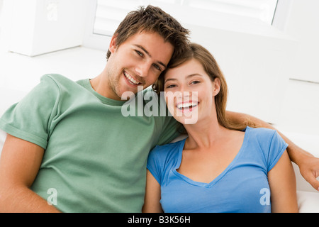 Couple in living room smiling Stock Photo