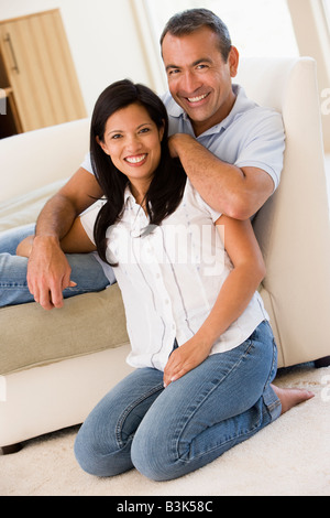 Couple in living room smiling Stock Photo