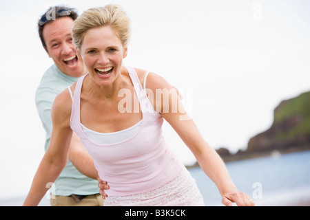 Couple at the beach smiling Stock Photo