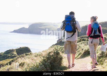 Couple on cliffside outdoors walking Stock Photo