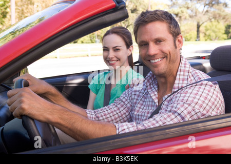 Couple in convertible car smiling Stock Photo