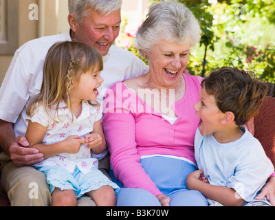 Grandparents laughing with grandchildren. Stock Photo