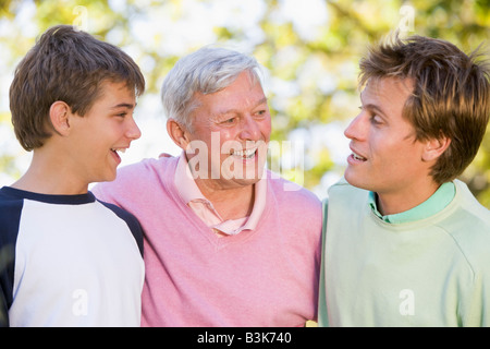 Grandfather with son and grandson smiling. Stock Photo