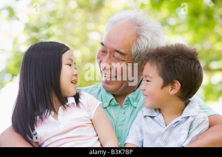 Grandfather laughing with grandchildren. Stock Photo