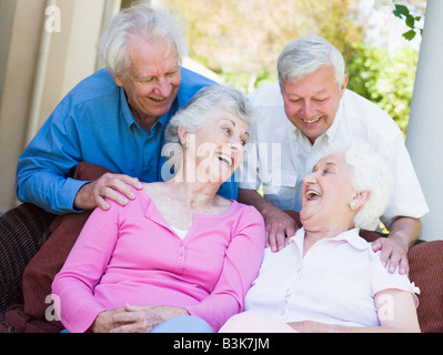 Two senior women sitting outdoors on a chair Stock Photo