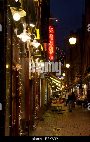 Neon lit exteriors of Restaurants along the Rue des Bouchers, Brussels Belgium Stock Photo