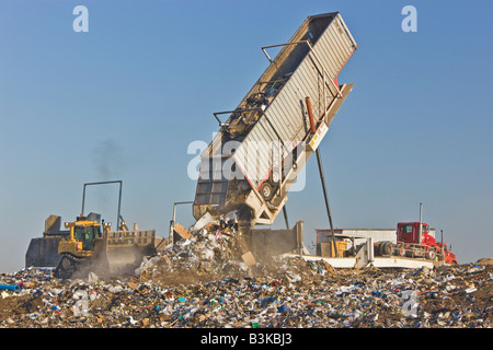 Tipper dumping semi trailer containing trash. Stock Photo