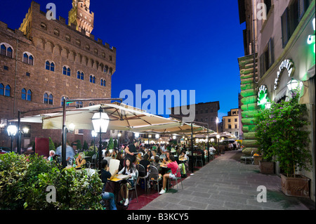 Restaurant at night in front of the Palazzo Vecchio in the Piazza della Signoria, Florence, Tuscany, Italy Stock Photo