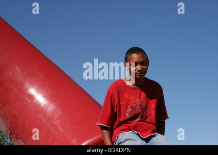 African american boy on playground equipment Stock Photo