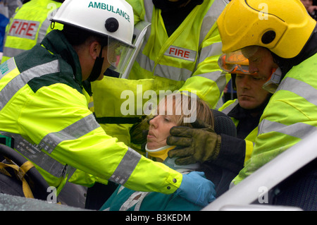 Emergency service personnel free an injured driver at the scene of a traffic accident during a training exercise Stock Photo