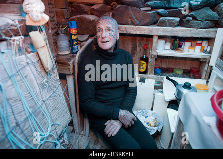 Tattooed hermit Tom Leppard (aka Leopard Man) comfortable in his secret makeshift underground hideaway shelter on Skye, Scotland Stock Photo