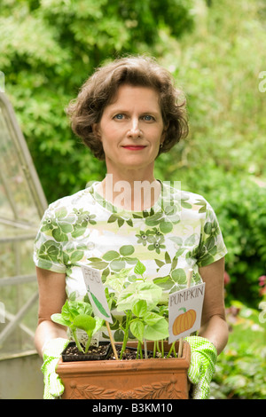 Woman Holding Pumpkin Seedlings In Garden Stock Photo - Alamy