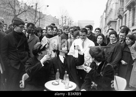 BEATLES at a cafe on the Champs Elysee in Paris January 1964 Stock Photo