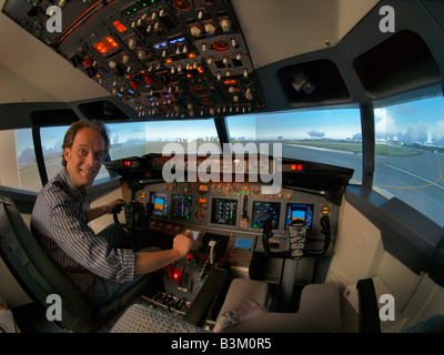 Student in flight simulator Boeing 737 cockpit parked on Schiphol airport ready for takeoff fisheye image Stock Photo